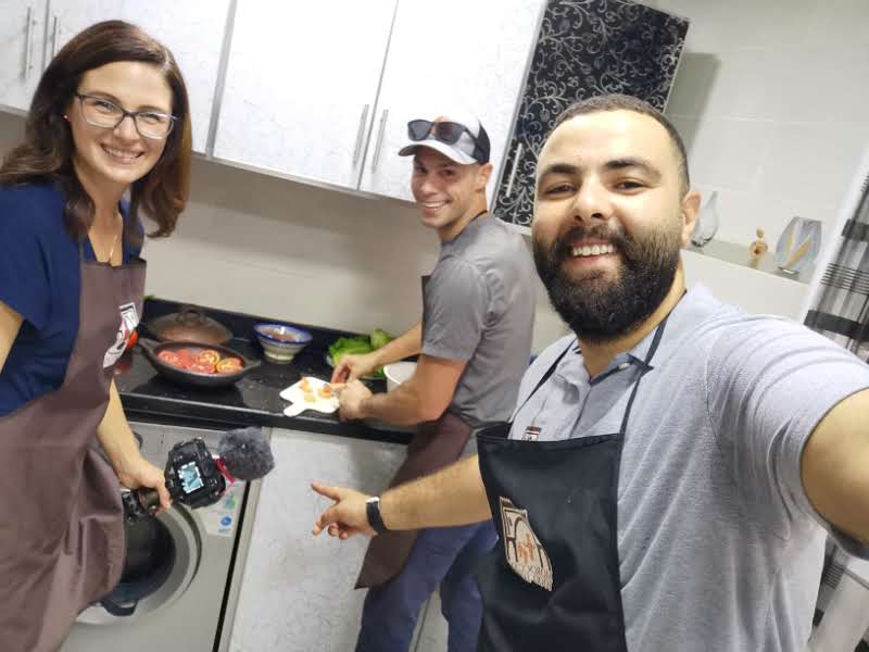 Guests cooking together in Morocco